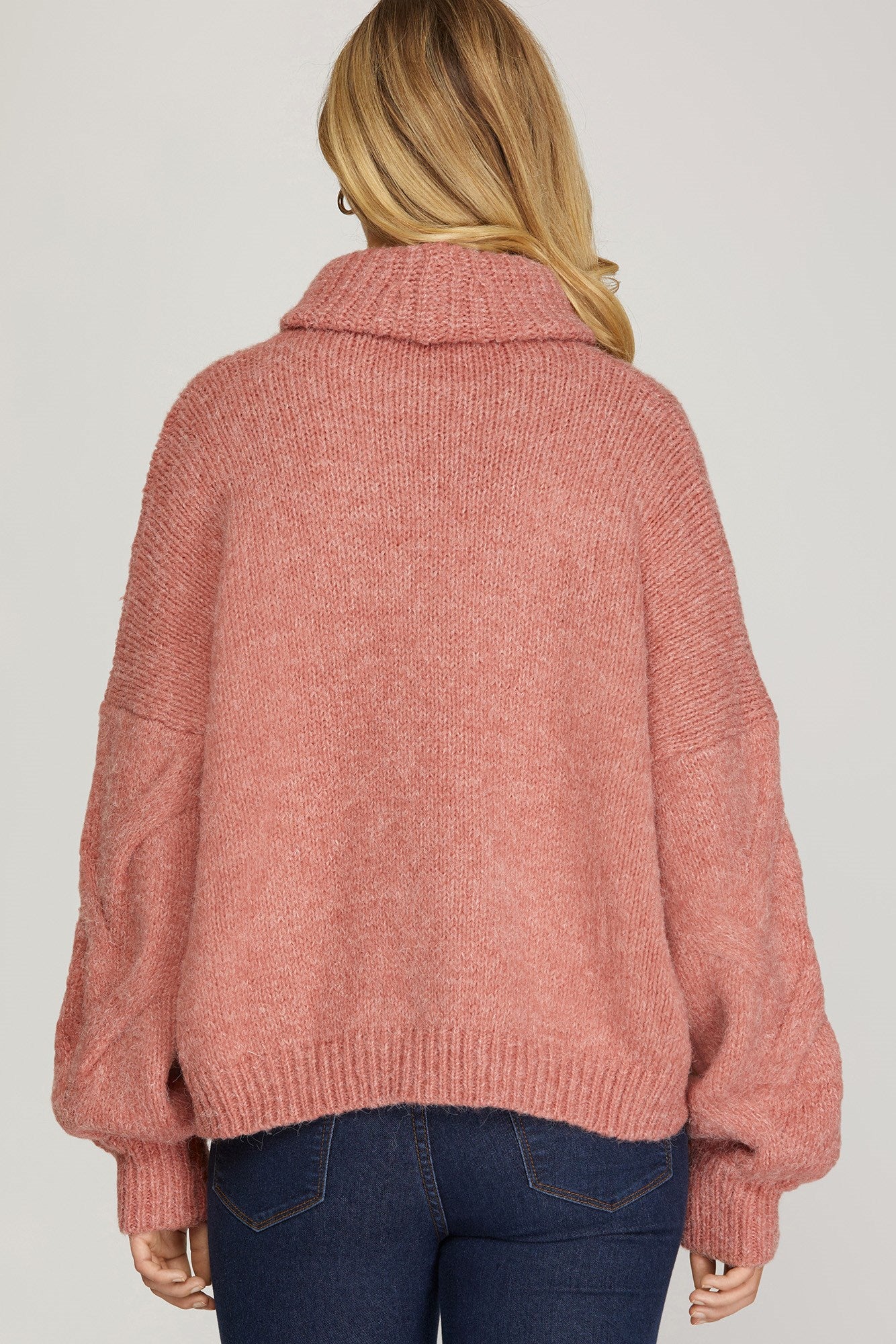 Long sleeved cable knit turtleneck sweater