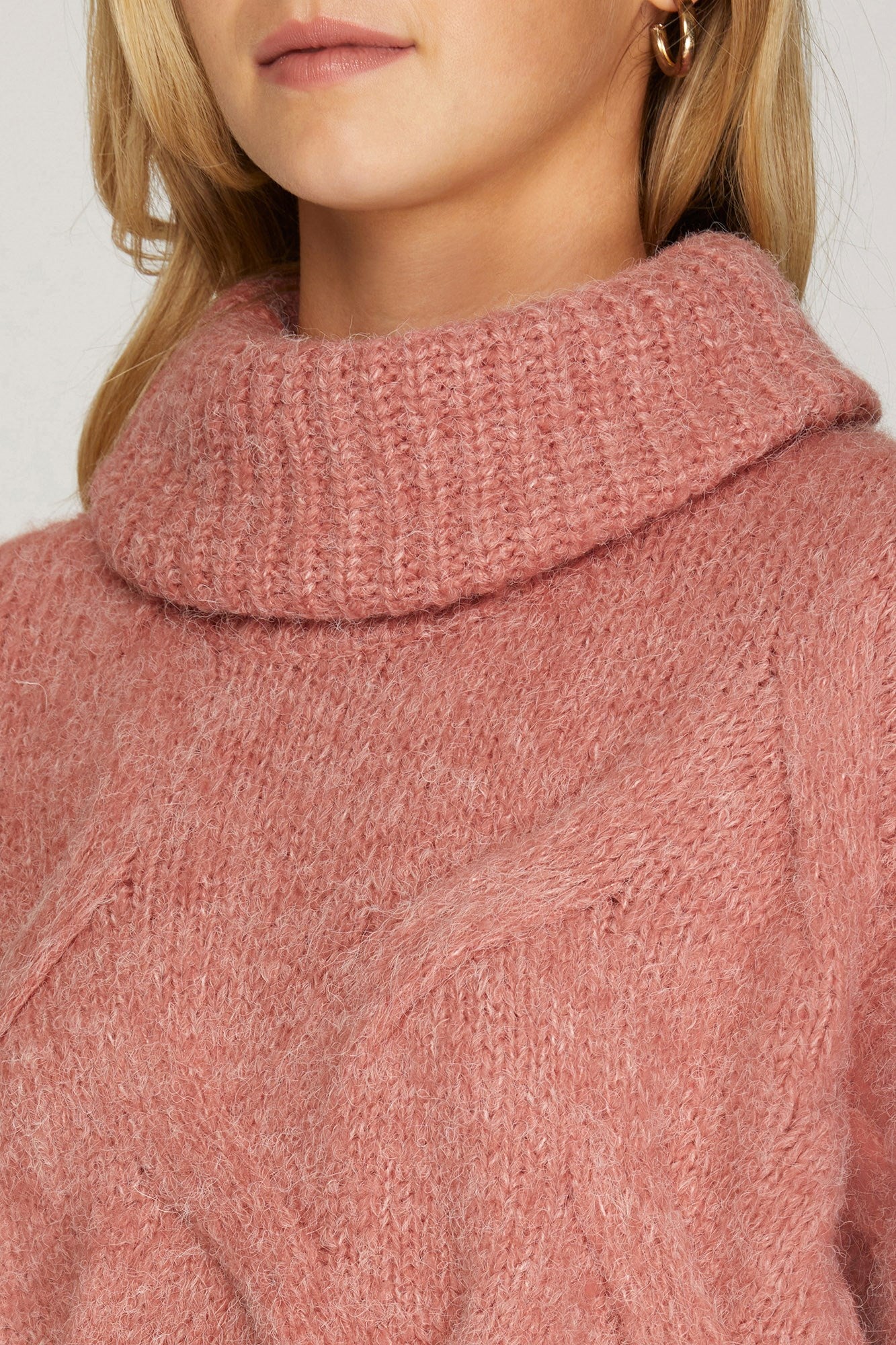 Long sleeved cable knit turtleneck sweater