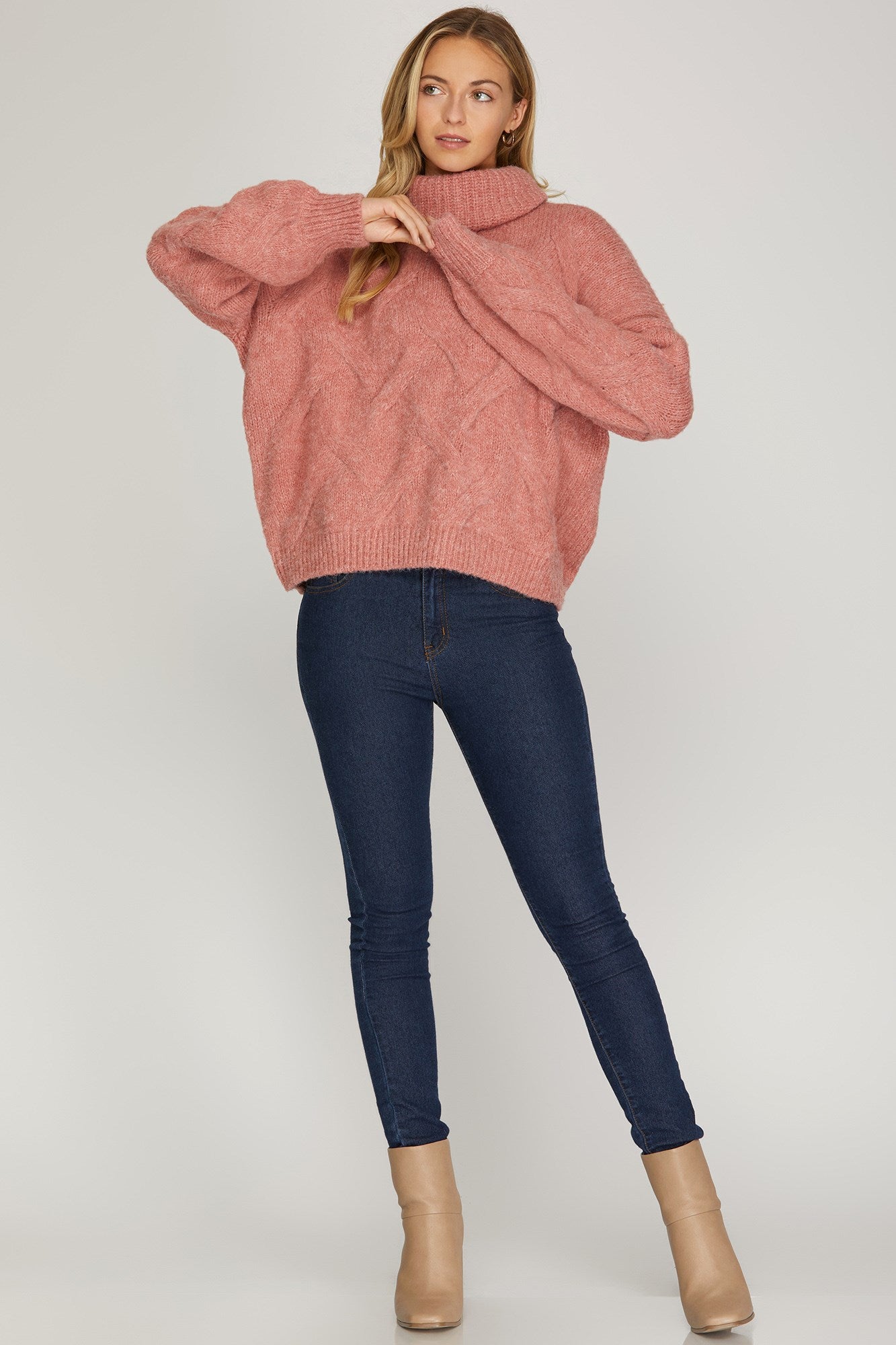 Long sleeved cable knit turtleneck sweater
